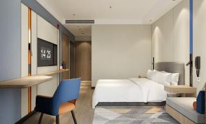 a bedroom with a bed and a desk and a chair at Holiday Inn Express Xi'an Daxing by IHG in Xi'an
