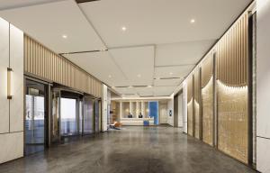 an office lobby with a long hallway with gold walls at Holiday Inn Express Xi'an Daxing by IHG in Xi'an