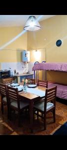 a dining room with a table and a bunk bed at Departamento Santa Teresita in Villa Unión