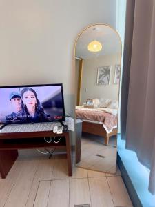 a room with a desk with a computer and a mirror at Cozy 1BR Condo with Uptown Mall View - BGC Zen Suite in Manila