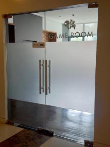 a glass door with a sign on it at Cozy 1BR Condo with Uptown Mall View - BGC Zen Suite in Manila