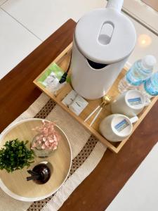 a table with a coffee maker and a bowl of food at Cozy 1BR Condo with Uptown Mall View - BGC Zen Suite in Manila