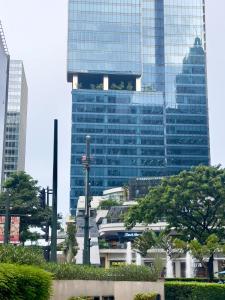 a tall building with many windows in a city at Cozy 1BR Condo with Uptown Mall View - BGC Zen Suite in Manila