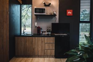a kitchen with a counter with a microwave at Tiny House 888 Pokolbin in Pokolbin