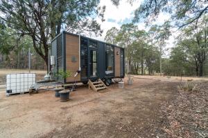 a tiny house in the middle of a field at Tiny House 888 Pokolbin in Pokolbin +13 photos