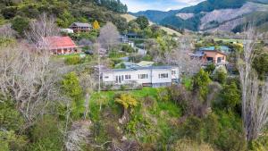 an aerial view of a house on a hill at Pukeko Cottage - Marlborough Sounds Retreat in Linkwater