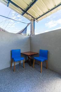 two blue chairs and a table in a room at Industrial Themed House in General Santos City in General Santos