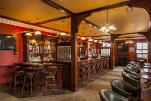 a bar in a restaurant with a bunch of chairs at Kilkenny House Boutique Hotel in Kilkenny