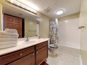 a bathroom with a sink and a toilet and a shower at Sea Dunes #401 in Fort Walton Beach