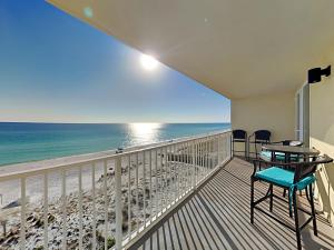 a balcony with a table and chairs and the beach at Sea Dunes #401 in Fort Walton Beach +20 photos