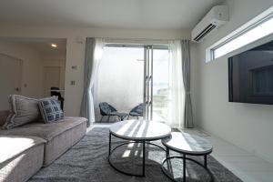 a living room with a couch and a table at Miyako Beach Resort in Hirara +30 photos