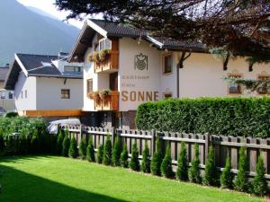 a fence in front of a building at Gasthof Sonne in Matrei in Osttirol