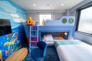 a childs bedroom with a blue bunk bed and a blue fish mural at Play!! RESI STAY in Kyoto