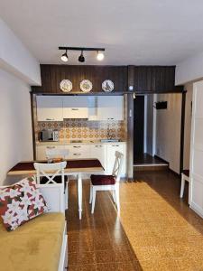 a kitchen with a table and chairs in a room at Casa Emma in Ecche