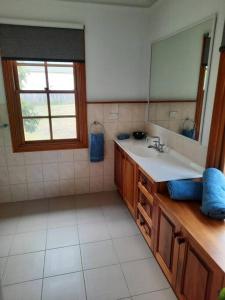 a bathroom with a sink and a mirror at Bairnsdale - Granite Creek Stays in Lucknow