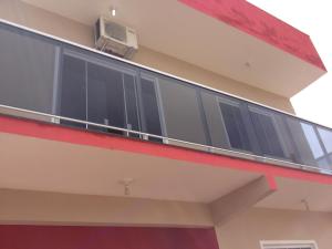 a balcony on the side of a building at Pousada Suite Master Bella Mar in Penha