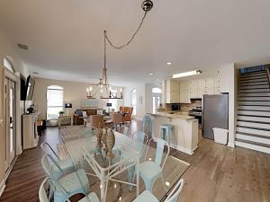 a dining room and kitchen with a glass table and chairs at Changes In Latitude in Destin