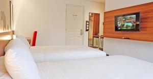 Letto o letti in una camera di Front One Resort Magelang