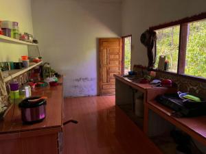 a kitchen with a wooden counter and a wooden floor at Batu Ridi Jungle in Timbanglawang