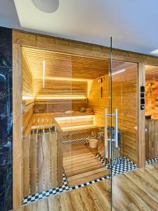 a sauna with a glass door in a room at Boutique hotel & Wellness Spitzerova vila Eliška in Janovice