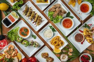 a table with many different types of food on plates at Beach Republic Koh Samui in Lamai +43 photos