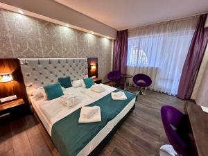 Postel nebo postele na pokoji v ubytování Bástya Konferencia és Wellness Hotel