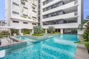an image of a swimming pool in front of a building at Avalon Resort Maroochydore in Maroochydore
