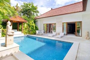 a swimming pool in the backyard of a villa at Villa Nemia Seminyak in Seminyak