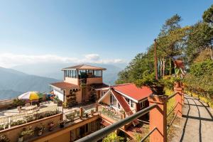 a house with a view of a mountain at Little Singamari Home Stay in Darjeeling