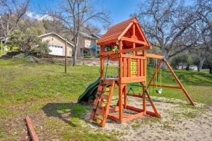 a wooden playset with a ladder and a house at Selah Cabin- Dog Friendly/BBQ/Level 2 EV Charger in Yosemite Forks