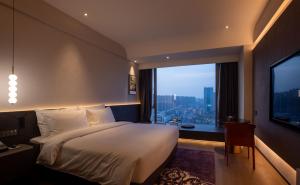 Postel nebo postele na pokoji v ubytování Maison New Century Hotel Cixi Hangzhou Bay