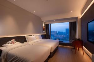 Postel nebo postele na pokoji v ubytování Maison New Century Hotel Cixi Hangzhou Bay