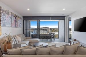 a living room with a couch and a tv at Avalon Resort Maroochydore in Maroochydore