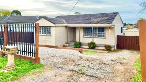 a white house with a fence in front of it at St Marys Affordable 5 Br cozy House in St Marys