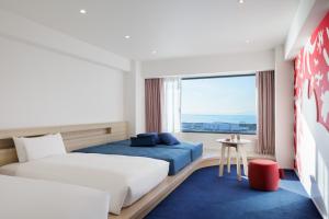 a hotel room with a bed and a window at RISONARE Osaka in Osaka +29 photos