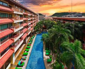 an aerial view of a resort with a pool and palm trees at Baumanburi Hotel Patong in Patong Beach