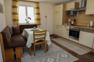 a small kitchen and dining room with a table and chairs at Apartments Gabl in Schönwies