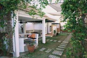 an outside area of a white house with a patio at Urban Glamp Resort Iloilo in Oton