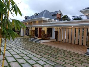 a house with a courtyard in front of it at Twin Cottages in Thekkady