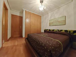 a bedroom with a bed and a chandelier at Marel Valladolid in Aldeamayor de San Martín +36 photos