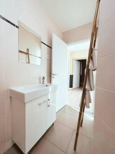 a white bathroom with a sink and a shower at PARISIAN ROMANTIC - 4 Pers - Wifi in Chatou +6 photos