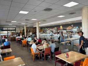 a group of people sitting at tables in a restaurant at Hotel Javalambre in La Puebla de Valverde