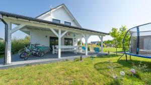 a white house with bikes parked on a porch at Dom Marcello with jacuzzi, Sun & Snow in Zastań