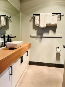 a bathroom with a sink and a mirror at Marengo Beach Studios- Pet Friendly in Marengo +23 photos