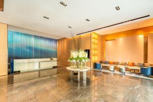 a lobby with a table with flowers on it at Holiday Inn Express Binzhou City Center by IHG in Binzhou
