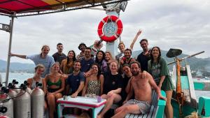 a group of people posing for a picture on a boat at Scubadoo house and Diving in Ko Tao