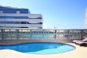 a swimming pool on the roof of a building at Citadines Metro Central Dubai in Dubai