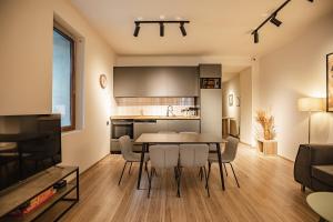 a kitchen and living room with a table and chairs at La Maison Mestia in Mestia