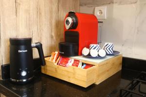 a coffee maker sitting on top of a counter next to a table at Dar Ibn Majdoub Lala aicha & Alia in Fès