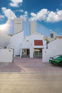 a green car parked in front of a building at Beautiful private villa with pool in Dubai